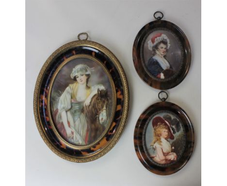 An oval miniature portrait of a young lady beside a horse, signed V I Copper, 14cm by 10cm, together with two head and should