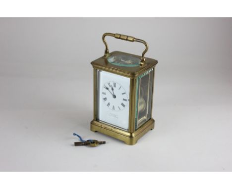 A French brass carriage clock, the white enamel dial with Roman numerals, inscribed 'Hamilton &amp; Co Calcutta, Made in Fran