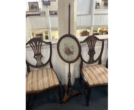 A 19th century rosewood pole firescreen with adjustable glazed oval tapestry panel on bluster support and triform base woth b
