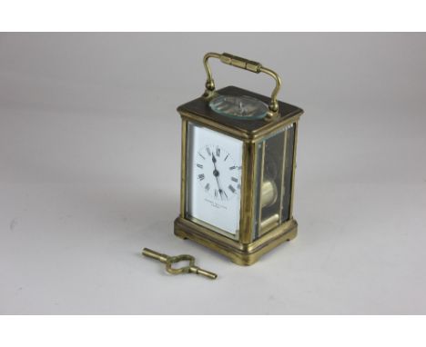 A 19th century brass carriage clock by Mappin Brothers London, the white enamel dial with Roman numerals, striking on a gong,