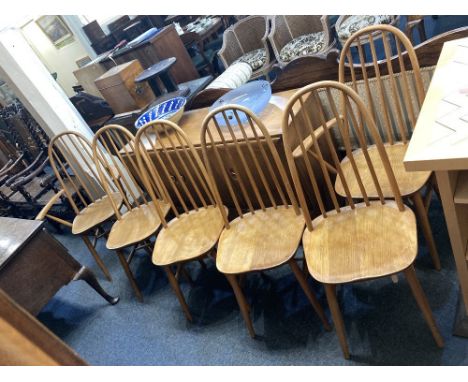A set of six Ercol style light elm dining chairs, including two carvers