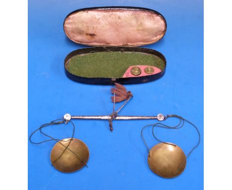 A cased set of steel and brass travelling beam scales, with coin weights