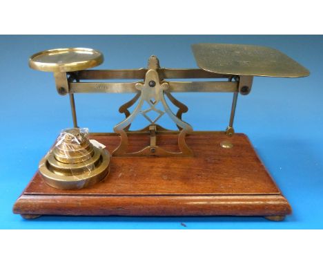 A set of Avery brass framed postage or similar scales with weights to base 