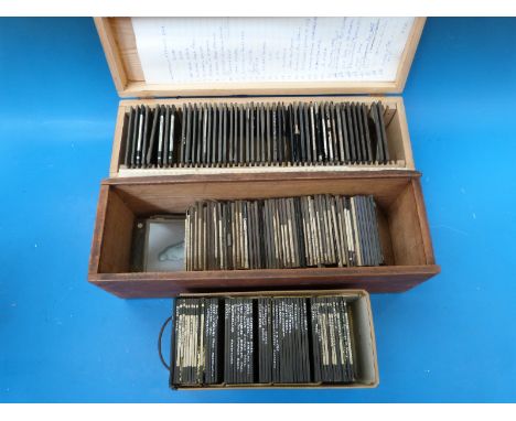 A collection of magic lantern slides in cases to include sculptures, ships, Niagara Falls, Zambesi Suspension Bridge, Egypt e