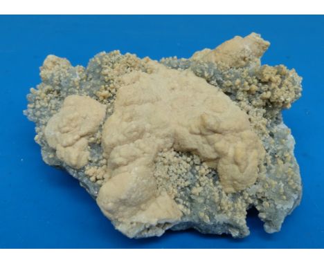 A geological sample formed of clusters of grey crystal with lighter surface to some parts, approximately 12cm long

