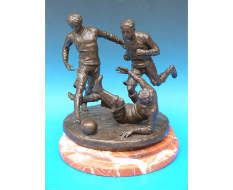 A bronze of three possibly 19thC footballers, on shaped marble base, height 34cm 