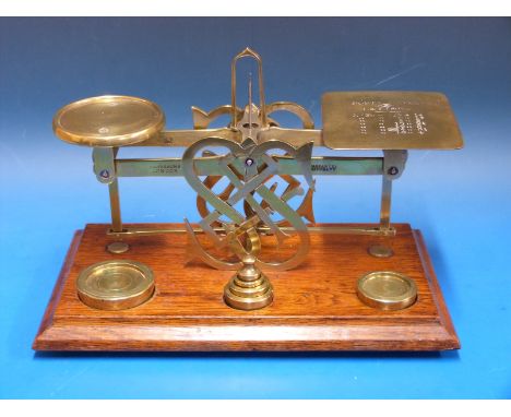 A set of probably Mordan postage scales, marked to beam Shaw & Sons London, the A frame formed as a fretwork monogram S&S, ha