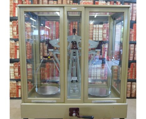 A large Avery DeGrave County Council of West Midlands 25kg beam scale in glass case with sash type sliding doors, width of ca