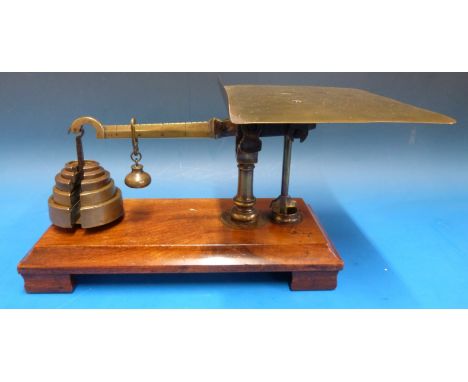 An unusual set of likely W&T Avery parcel scales on a mahogany base, together with weights