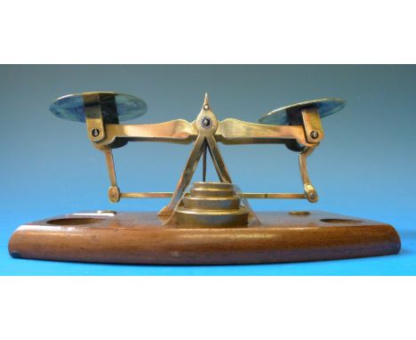 A set of brass postage scales on wooden base with weights 