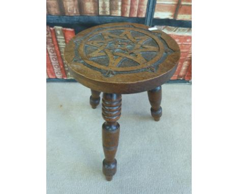 A late 19thC / 20thC carved oak Arts and Crafts stool
