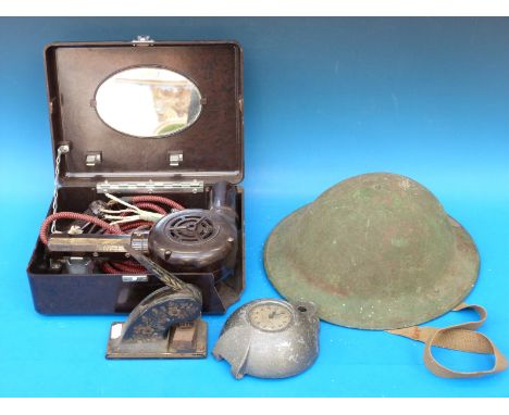 A WWI military helmet, vintage hairdryer, recorder clock and a letter punch 