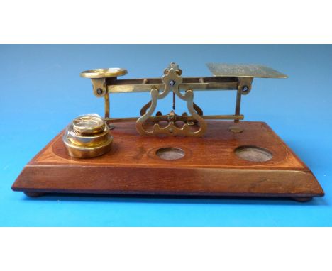 A set of brass postage scales, the inlaid base set with weights