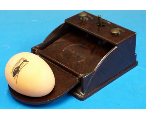 A Bakelite lightning egg grading scale with buttons for first, second and third