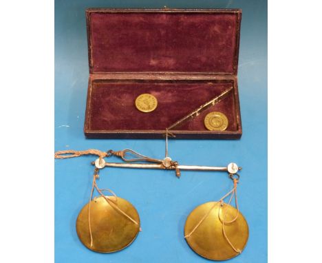 A leather-cased W & T Avery hand-held beam scale with steel beam, brass pans and Royal Mint 1843 half and full sovereign weig