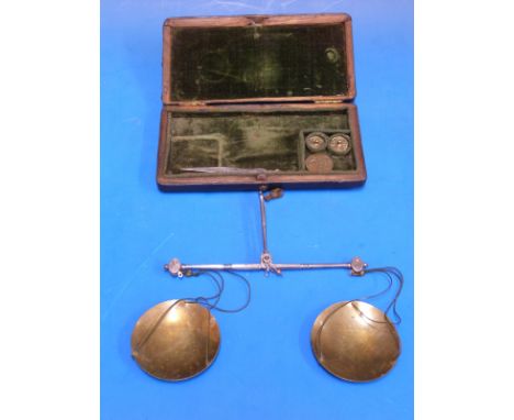 A cased set of De Grave travelling beam scales, the velvet-lined case with tweezers and coin weights