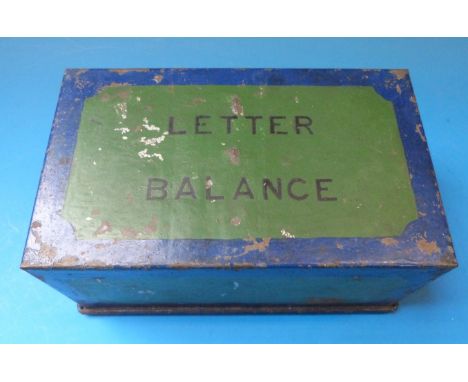 A set of brass postage scales with weights to the wooden base, in tin travelling box