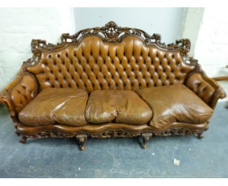 A 19thC style carved walnut and leather sofa and two side chairs (L213cm)