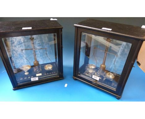 A glass cased set of D. Koritschoner diamond beam scales with weights from 100 to 5 