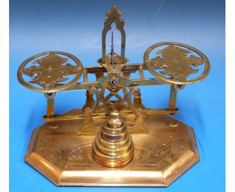 A set of probably Mordan postage scales having pierced and engraved pans and A frame, the octagonal base also engraved and mo