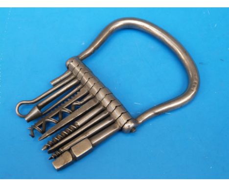 A 19thC B.B Wells West Strand steel multitool comprising corkscrew, screw, button hook etc, 11 tools in total within a loop s