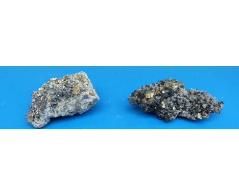 Two small geological samples formed of grey quartz, both with dark grey stone scattered between lighter crystals and also wit