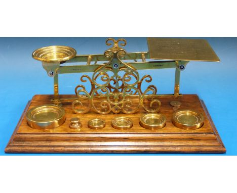 A set of S. Mordan & Co. postage scales raised on fine pierced scrolling supports, the pan listing inland, India and colonies