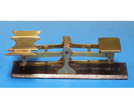A small set of possibly S. Mordan travelling scales, the pan with fold out wings, the base being leather covered