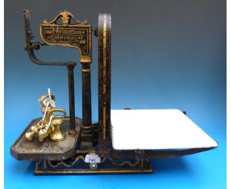 A set of 19thC F. Wedderburn cast iron shop scales with enamel pan, together with five bell weights, one marked Parnall & Son