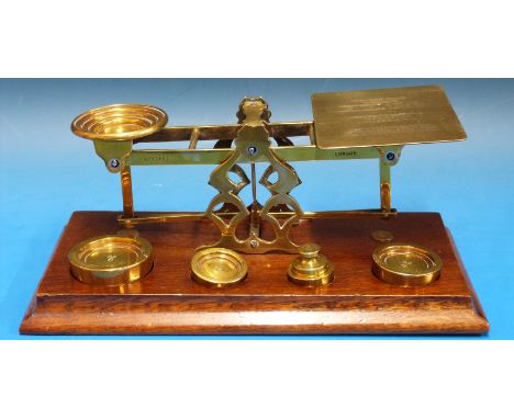 A set of S. Mordan & Co postage scales, supported on Arts Nouveau pierced A frame the pan marked with inlaid, British Empire 