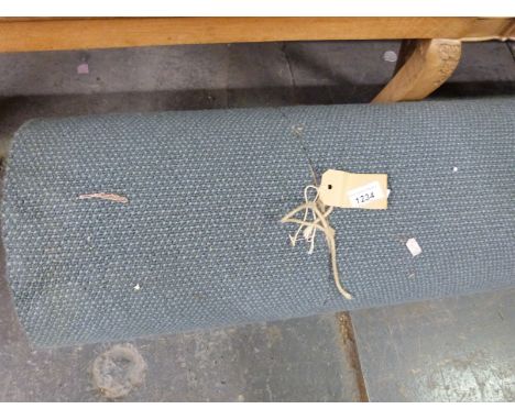 A large roll of unused carpet, label attached states 2M x 6M but not verified