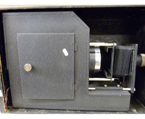 A large cased electric magic lantern by Triumph with adjustable lens, height adjustment to the bulb with reflector with bulb 