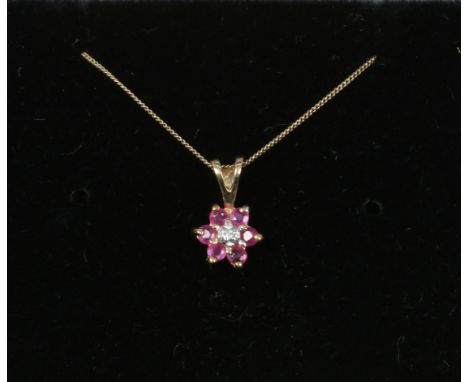 A 9ct gold ruby and diamond one cluster pendant on 9ct gold chain.