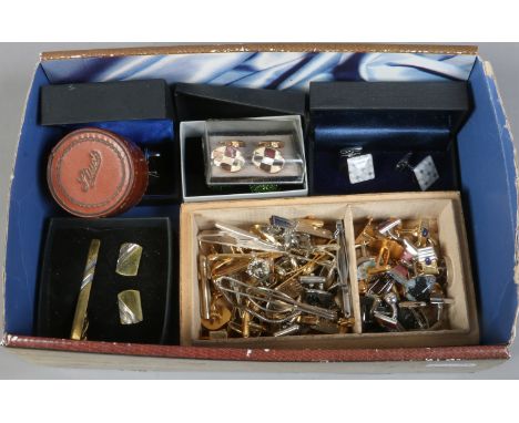 A box of miscellaneous cufflinks and tie pins.