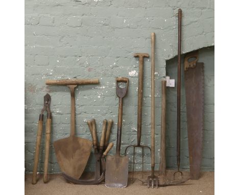 A quantity of garden tools, spades, pick fork etc.