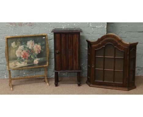 An oak dome top wall hanging display cabinet along with a mahogany pot cupboard and a metamorphic firescreen / occasional tab