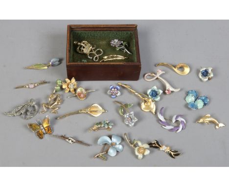 A small box of costume jewellery brooches including marcasite enamel and coloured paste examples.