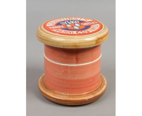 A Dewhurst Sylko ceramic sewing container in the form of a cotton bobbin  Condition Report. To be used as a guide only. Liner