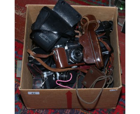 A box of vintage photographic equipment including a Pentax ME super 35mm SLR, a Pentax P30N, cased Zeiss Ikon Contaflex, lens