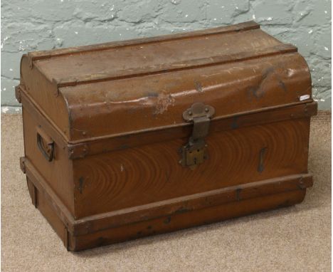 A painted vintage tin trunk with key.
