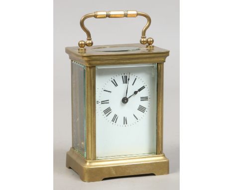 A brass cased carriage clock with white enamel dial, original key. Condition Report. To be used as a guide only. Some damage.