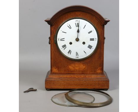 An oak cased dome top mantel clock with white enamel dial chiming on a coiled gong. Condition Report. To be used as a guide o