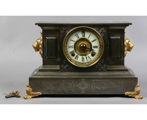 A 19th century ornate metal mantle clock housing a twin train movement by The Ansonia Clock Company New York with pendulum an