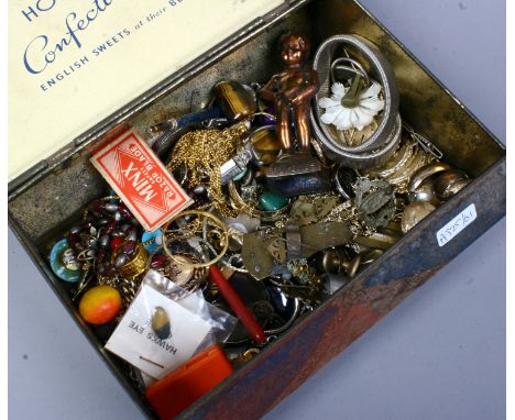 A vintage Horners Confectionary tin containing costume jewellery, collectables and curios including chains, badges and clip o