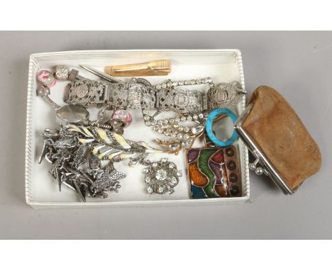 A box of costume jewellery including enamel and marcasite feather brooch, ladies wristwatch, white paste buckle and panel bra