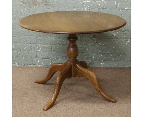 An Ercol circular dining table.