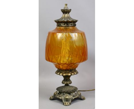 A large amber glass and brass effect tablelamp formed as an oil lamp.