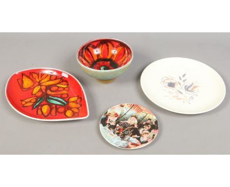 Four pieces of Poole pottery including plates, bowl and a commemorative example.
