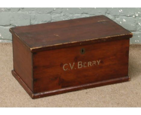 A vintage pine storage chest stencilled C. V. Berry.