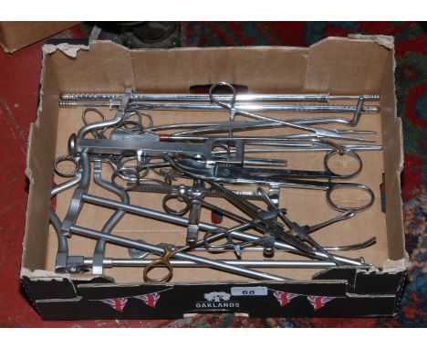 A box of steel surgical tools.